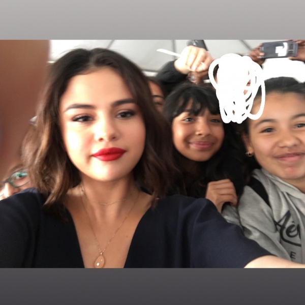 April 19: Selena with a fan at WE Day California in Inglewood, CA (credit: juice_coutinho_14)
